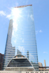 Photo of a glassed building with the sun shining off the windows, along with reflection of the Chicago skyline